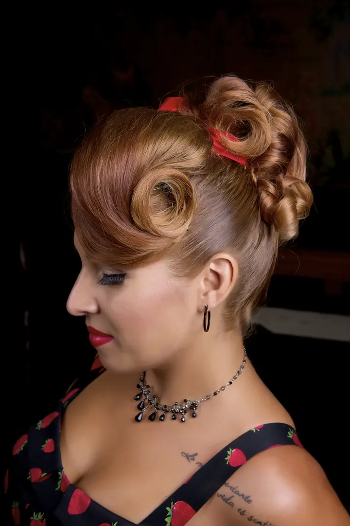 Pin-up victory-roll updo with a red bow