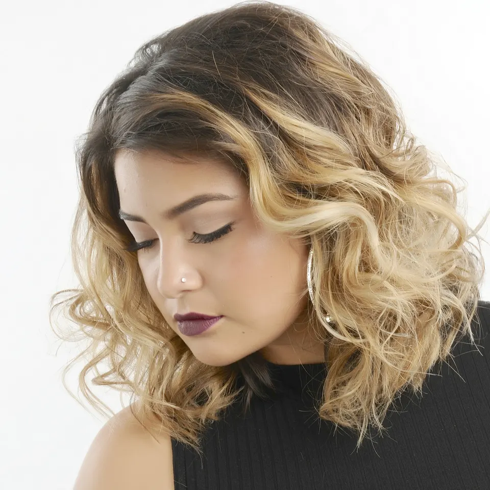 Shoulder-length curls with a dark-to-blonde balayage